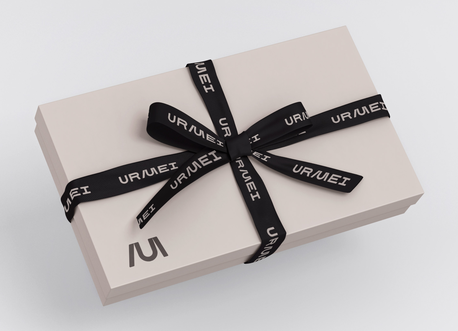 A URMEI gift box tied with branded ribbon.